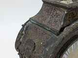 a clock that has a bird on top of it