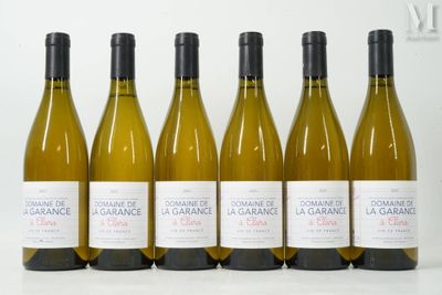 six bottles of white wine lined up in a row on a table