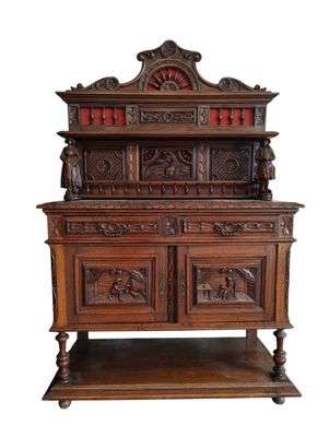an old wooden cabinet with carvings on top of it