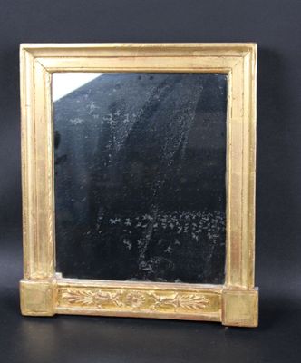 an image of a gold framed mirror sitting on top of a black table