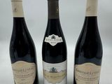 three bottles of wine sitting on top of a table next to each other
