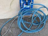 a hose attached to a blue hose on the ground