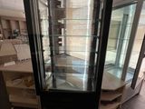 a glass display case in the middle of a room