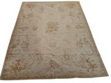 a large beige rug with a floral design on it