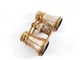 pair of antique brass and mother of pearl binoculars on a white background