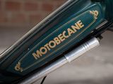 a close up of a motorbike that is parked on the street