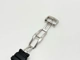 a close up of a watch on a white surface with a black strap