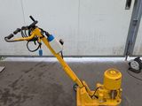 a small yellow machine that is sitting on the ground