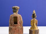two figurines that are sitting on a table