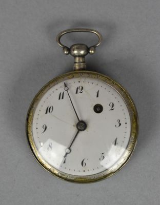 a close up of a pocket watch on a table