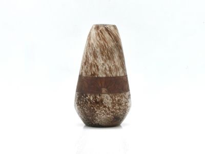 a small vase with a wooden handle on a white surface