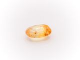a yellow sapphire stone on a white background