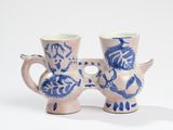 pair of blue and white vases on a white surface
