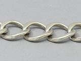 a close up of a chain bracelet on a white surface