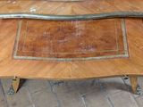 a wooden table with a metal handle on top of it