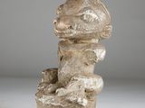 an image of a sculpture of a person sitting on top of a rock