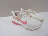 white and pink nike air max sneakers on a white surface
