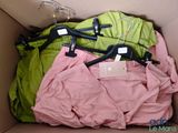 three pairs of pants in a box with hangers