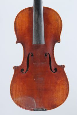 an old violin sitting on top of a stand on a white surface