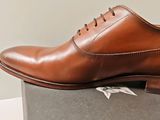 the brown shoes are sitting on top of a box