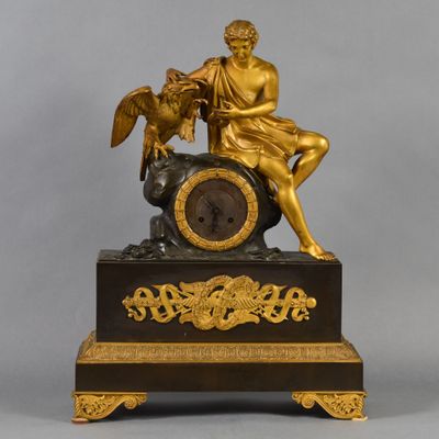 a statue of a man sitting on top of a clock