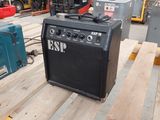 a guitar amp sitting on a pallet in a warehouse