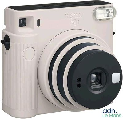 an image of a white camera with a flash light on top of it