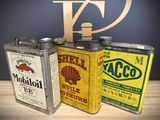 three tins that are sitting on a table