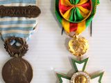 several medals and medals are displayed on a white surface