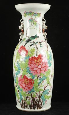 a white vase with flowers and birds painted on it