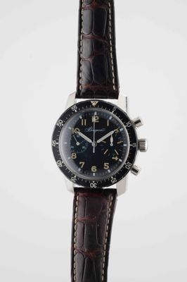 a close up of a watch on a white surface with a white background