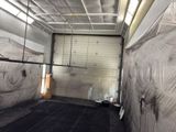 a picture of a garage with a lot of plastic covering the walls