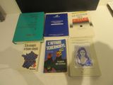several books are sitting on a table next to each other