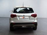 a silver car parked in a room with a white wall