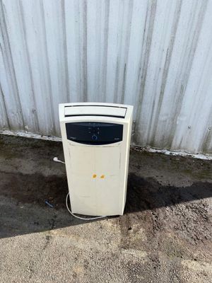 a white refrigerator sitting in front of a metal wall