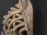 a close up of a wooden sculpture of a bird with feathers