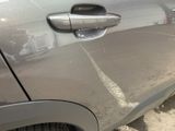 a close up of a car ' s door handle on the side of the road