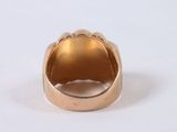 an image of a gold ring on a white surface