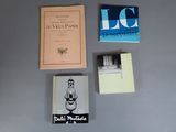 several books on a table with a book on top of it