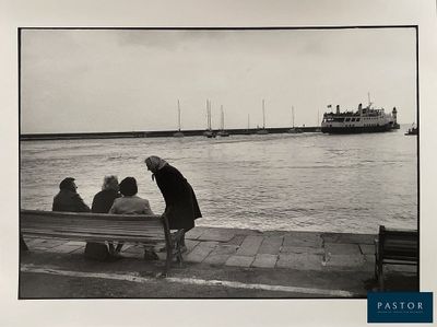 black and white photograph of a group of people sitting on a bench