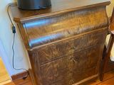 a wooden table with a lamp on top of it