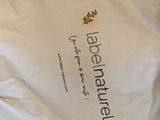 a white shirt with a black and yellow logo on it