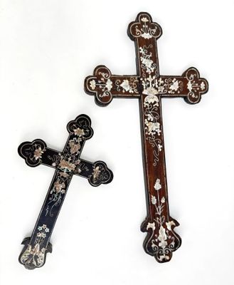 two crosses that are sitting next to each other on a table