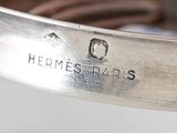 a close up of a silver bracelet with a name on it