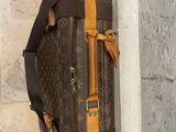 a brown and tan bag hanging on a wall
