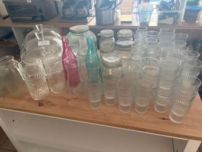 de nombreux verres et bocaux sur le plan de travail de la cuisine