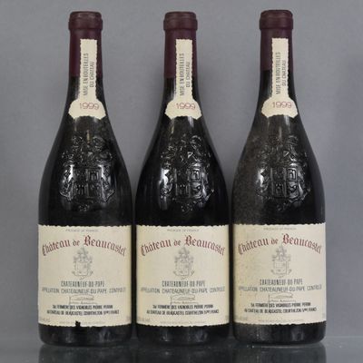 three bottles of wine are lined up on a table