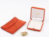 an orange case with a ring inside of it on a white surface