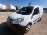 the white van is parked in a parking lot near a building