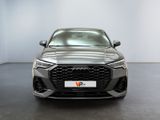the front of a grey audi q4 parked in a showroom